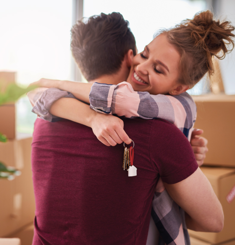 First Time Home Buyers hugging